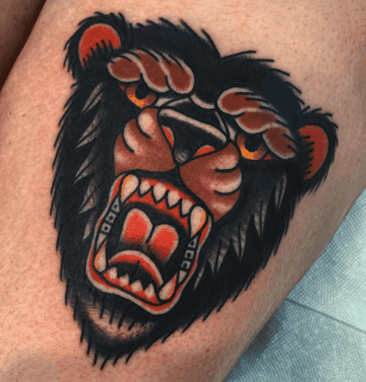 A tattoo of a bear face.
