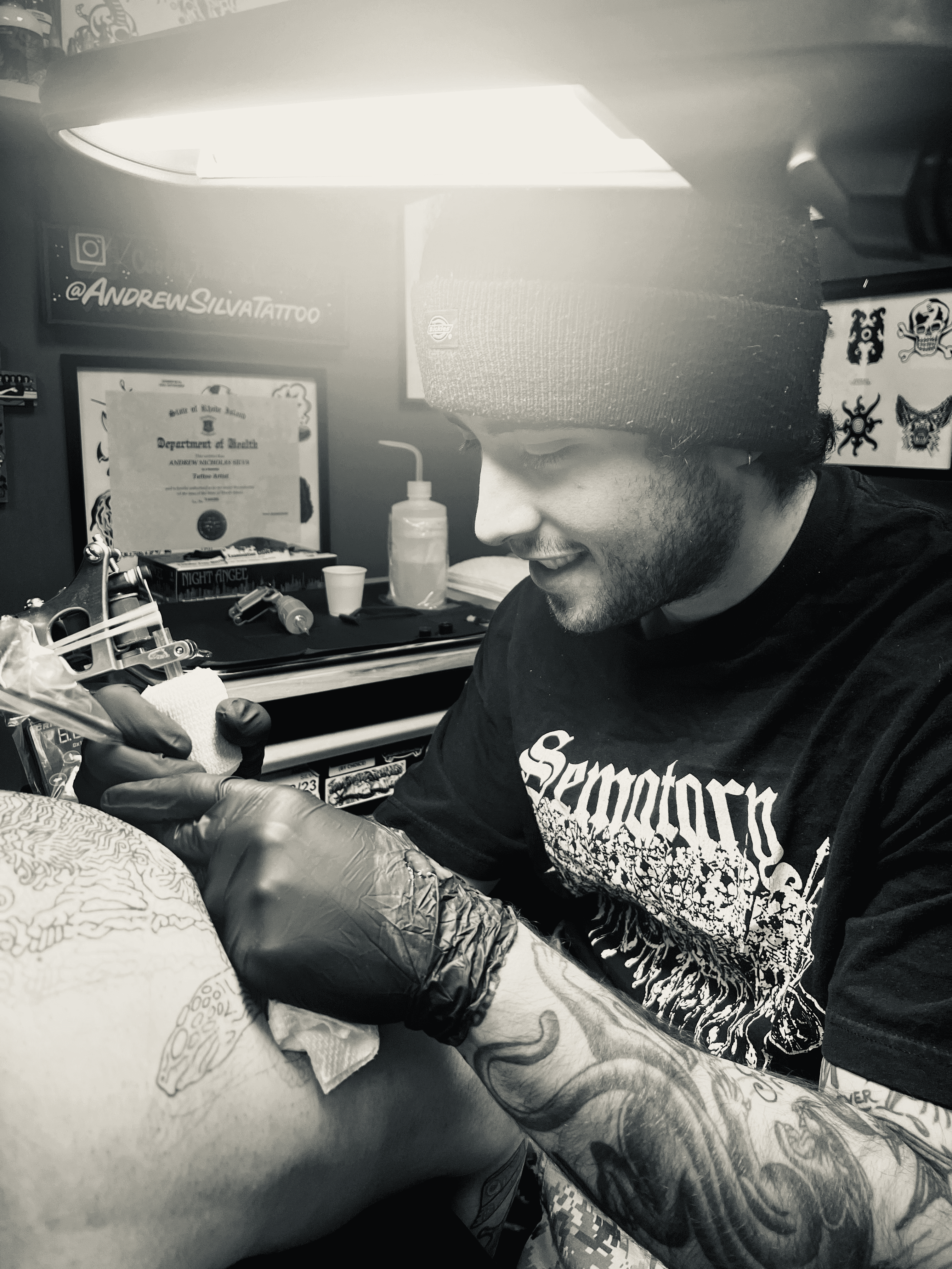 Artist giving a tattoo.