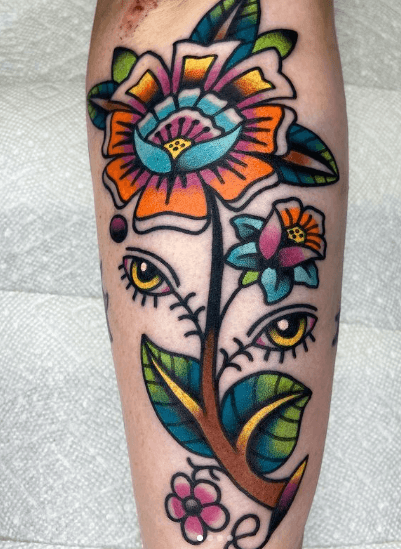 Tattoo of a flower with eyes for leaves.