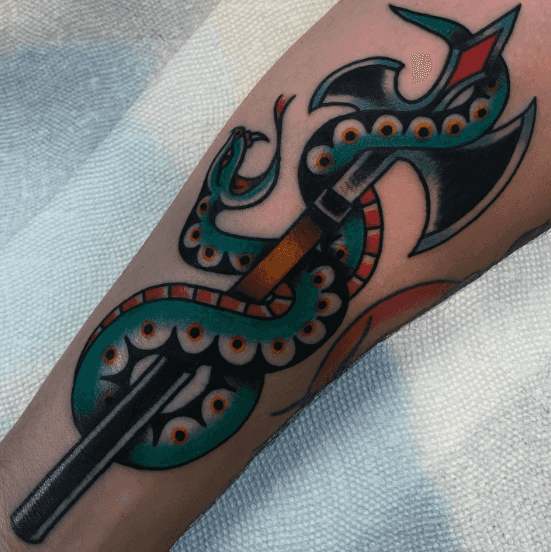 A tattoo of a snake wrapped around a medievel axe.