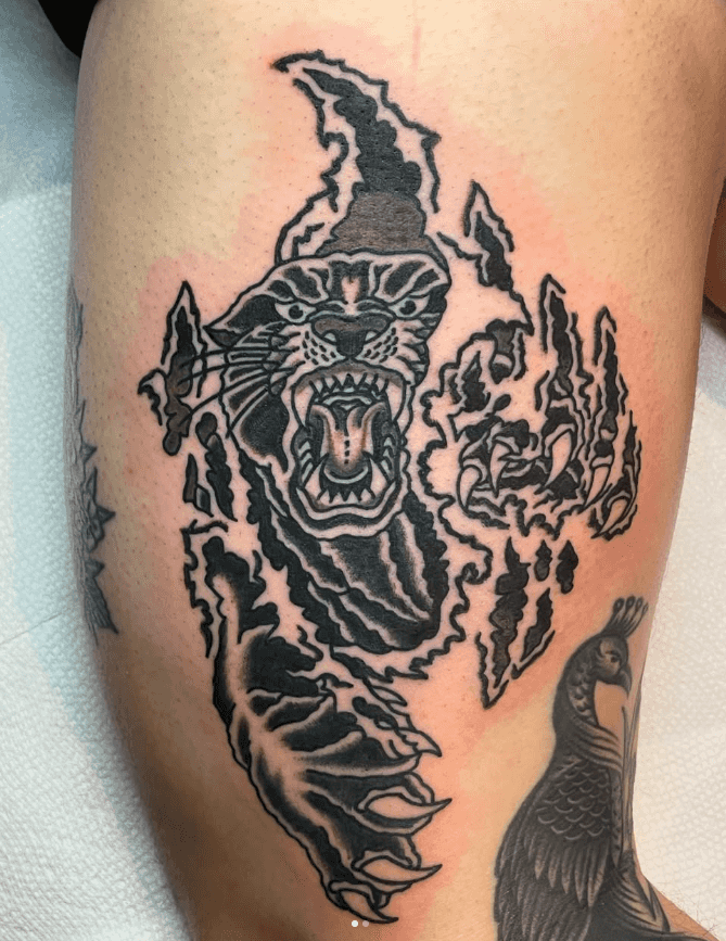 Black and white tattoo of a panther.
